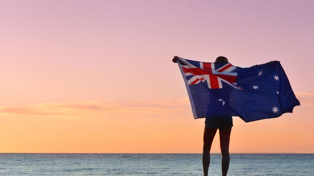 Person holding the Australian flag at sunset