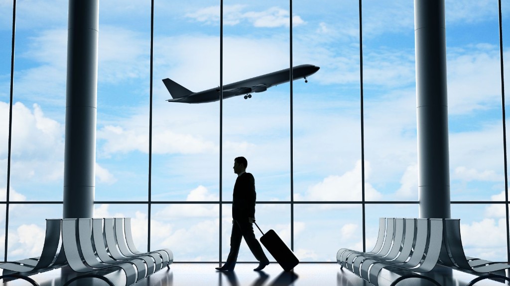 Traveller walking through an airport terminal with a suitcase