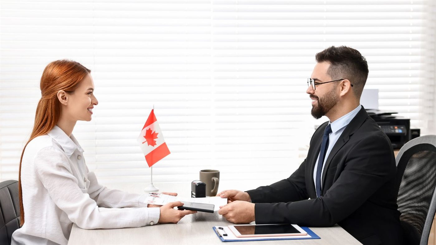 Immigration consultant assisting a client with Canada PR documents
