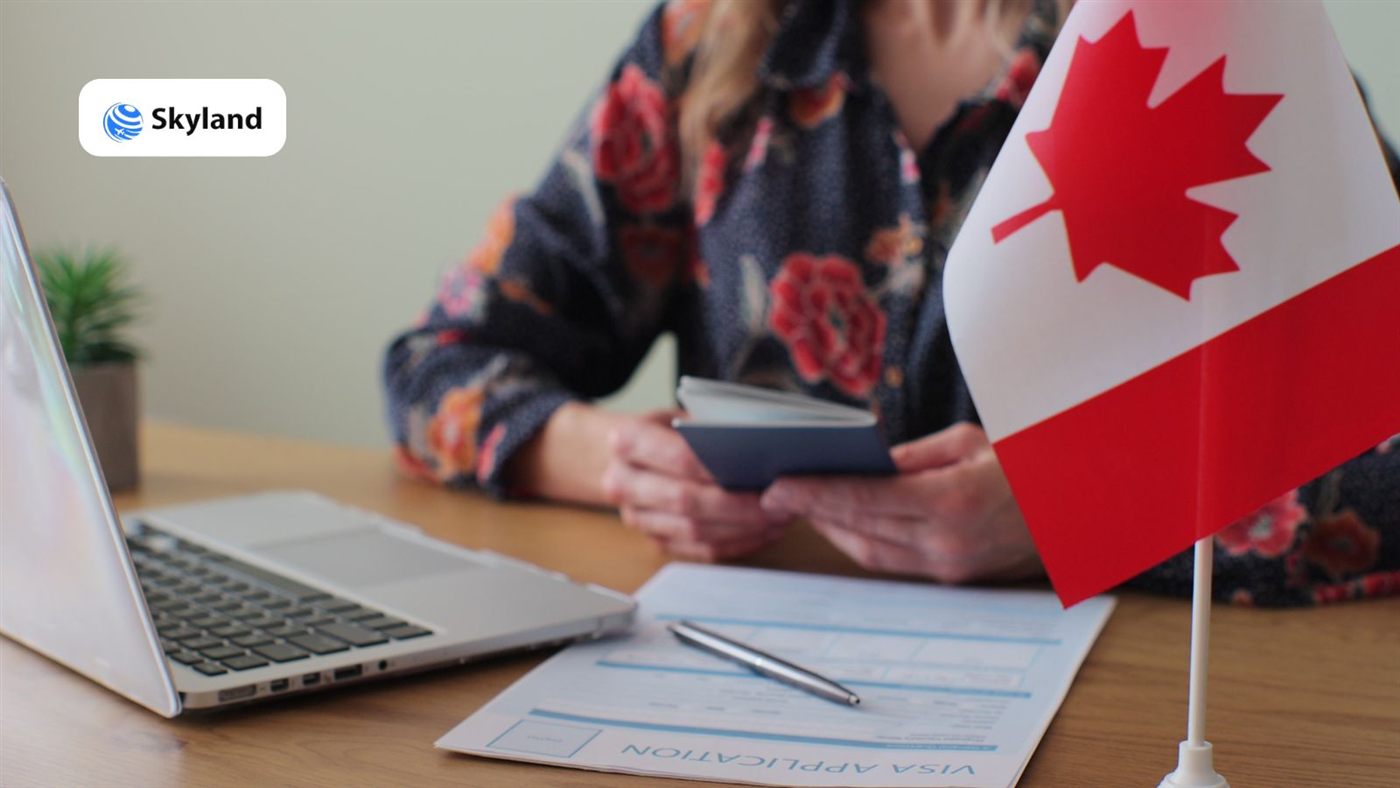 Applicant preparing a Canada visa application with passport and form