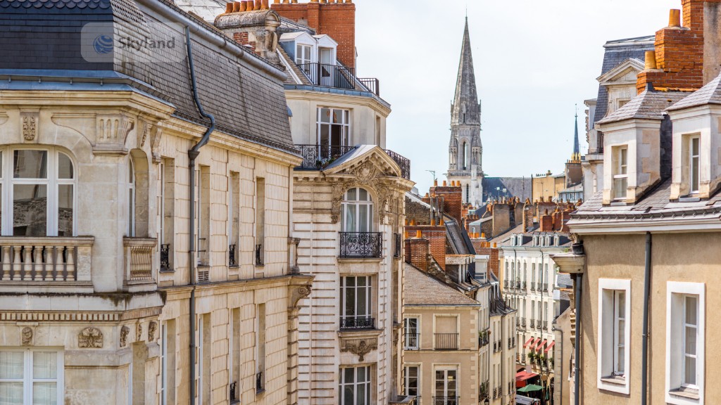 Traditional French city rooftops and church spire