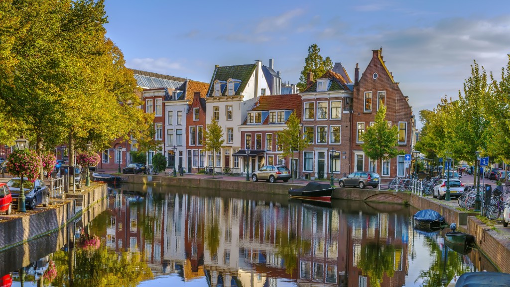Amsterdam canal at dusk with lit townhouses