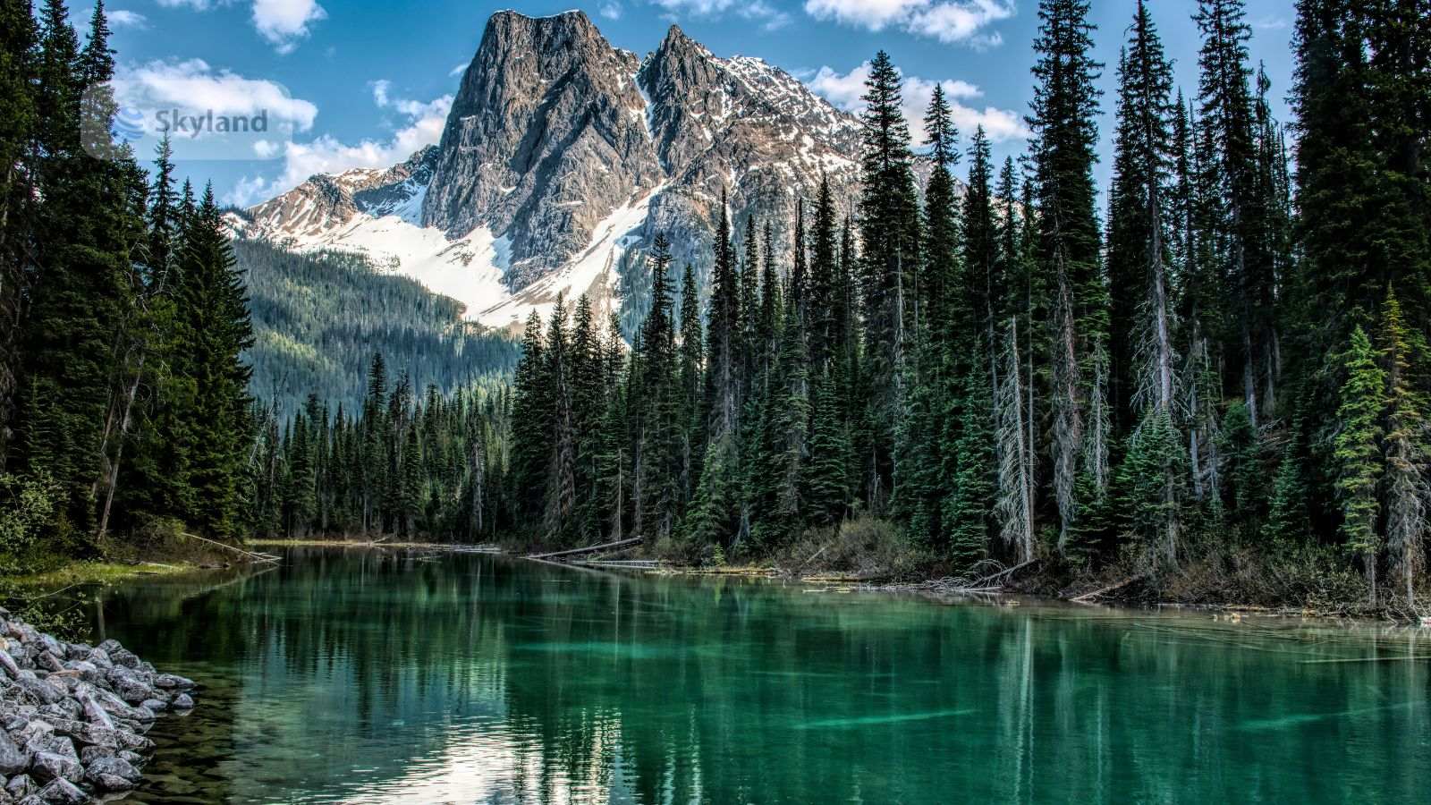 Turquoise alpine lake and mountain peak in British Columbia