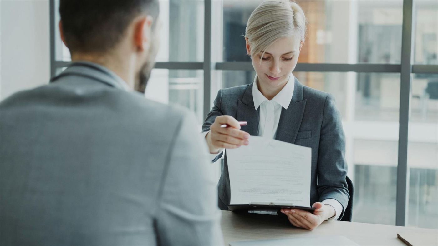 Immigration consultant reviewing MPNP documents with a client