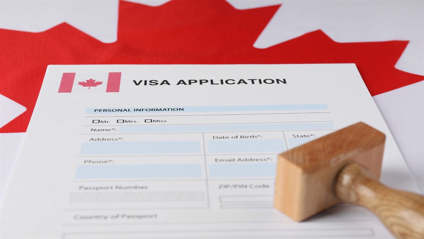 Canada visa application form on the Canadian flag