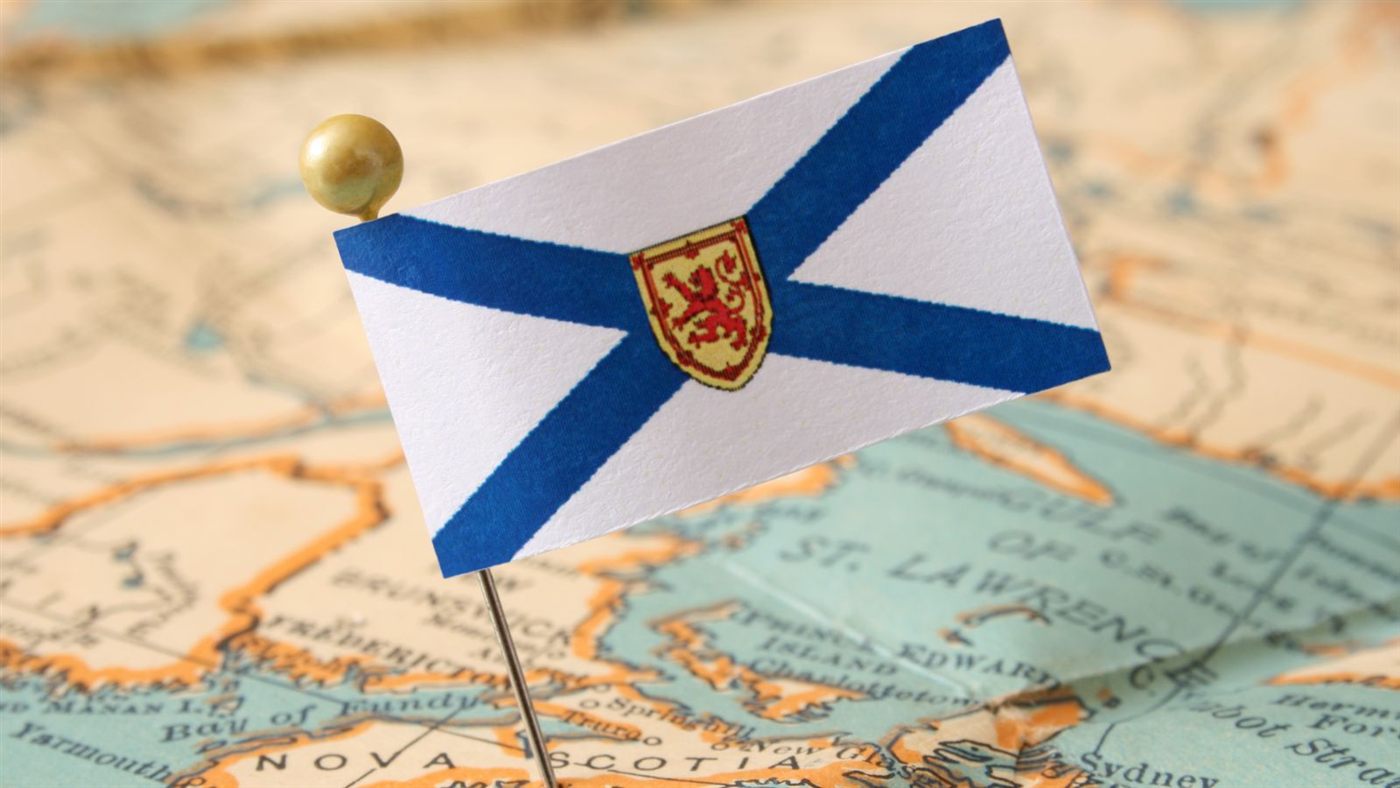 Nova Scotia flag pinned on a map of Atlantic Canada