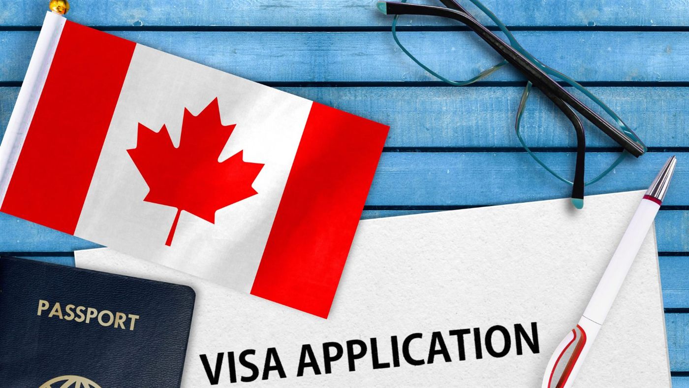 Visa application, passport and Canadian flag