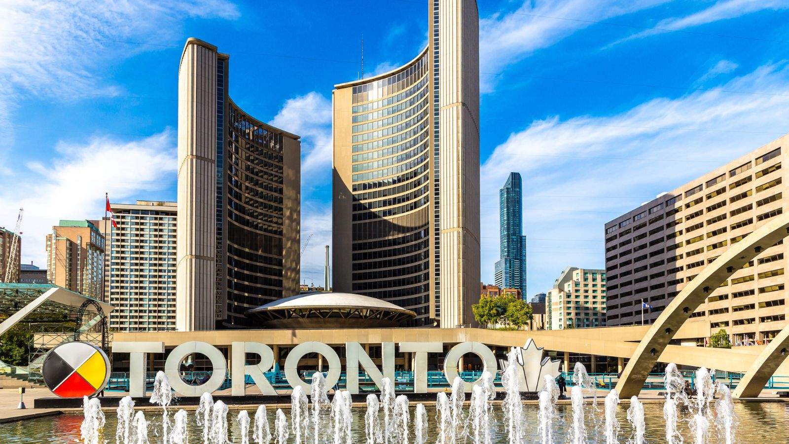 TORONTO sign and City Hall at Nathan Phillips Square