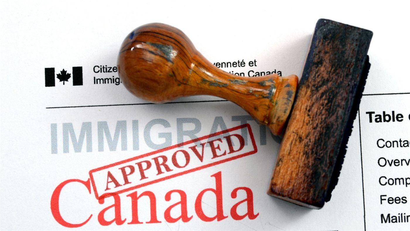 Canadian visa application on a clipboard