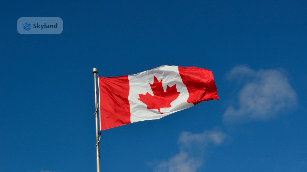 Canadian flag waving against a blue sky