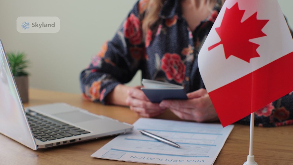 Woman completing a Canada visa application with passport and flag