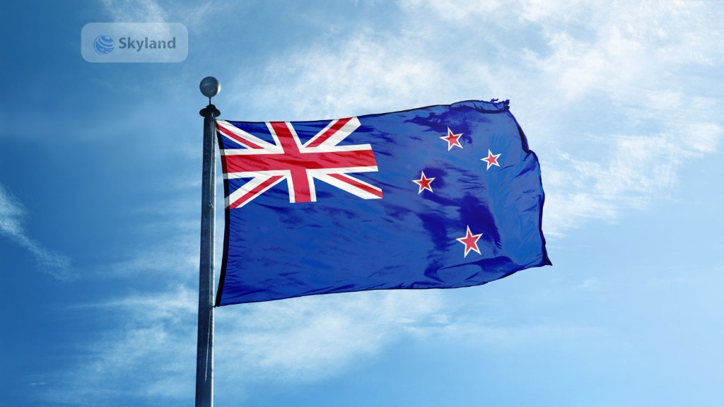 New Zealand flag waving against a blue sky