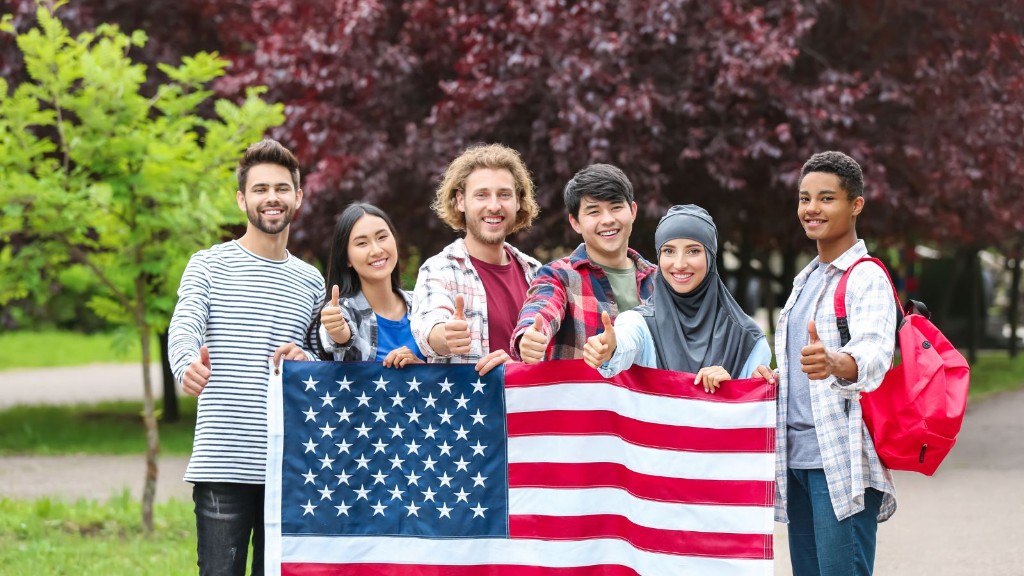 Students holding an American flag and giving a thumbs up