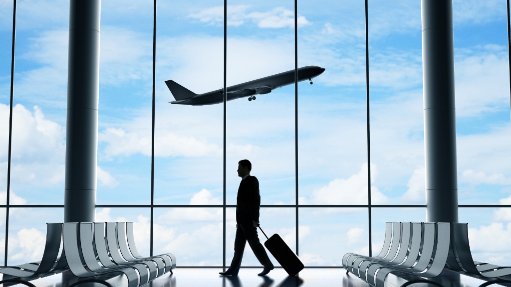 Traveller at an airport terminal preparing a visitor visa application